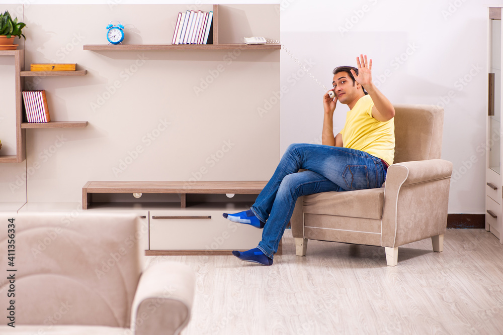 Young man student talking by phone at home Young man student talking by phone at home