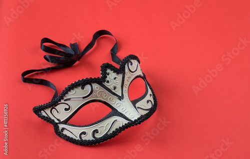 masquerade mask on a red background photo