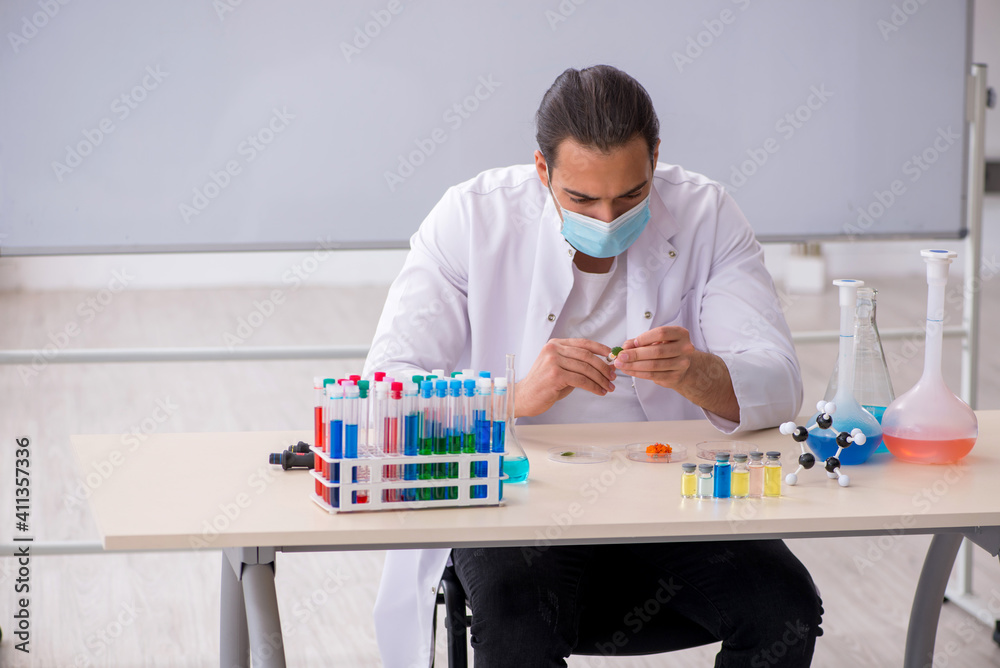 Young male chemist working in the lab Young male chemist working in the lab
