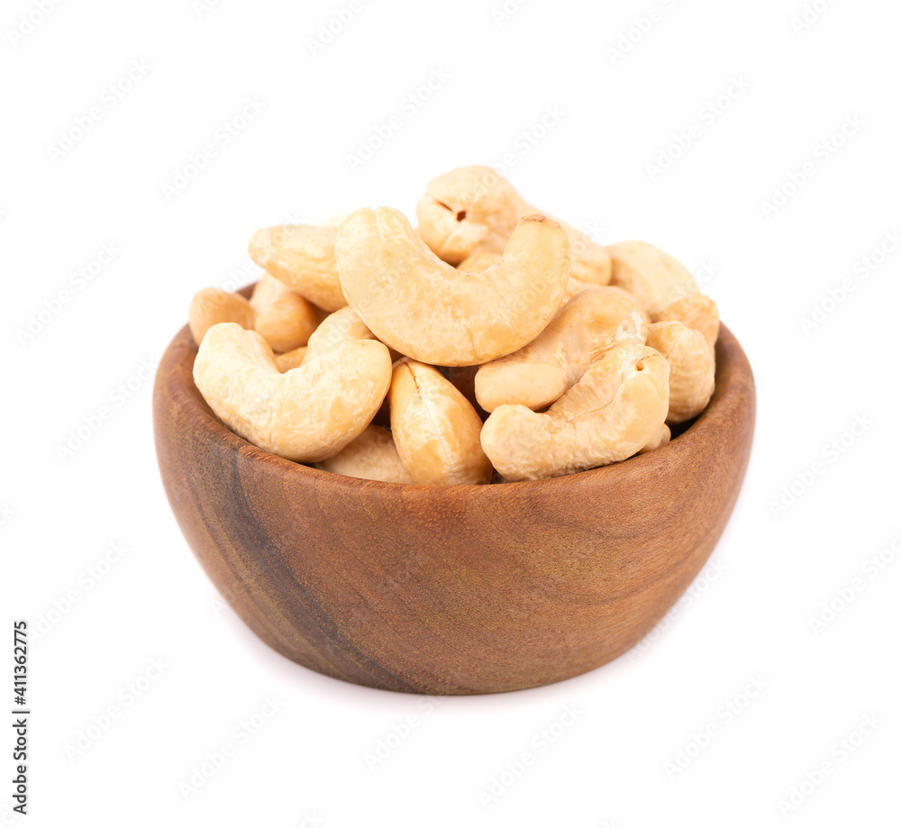 Cashew nuts in wooden bowl, isolated on white background. Roasted cashew nuts. Cashew nuts in wooden bowl, isolated on white background. Roasted cashew nuts.
