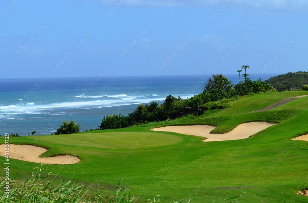 A golf course nestled along the shores of the Pacific ocean in Hawaii