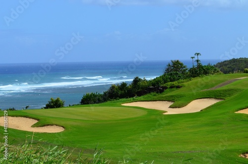 A golf course nestled along the shores of the Pacific ocean in Hawaii