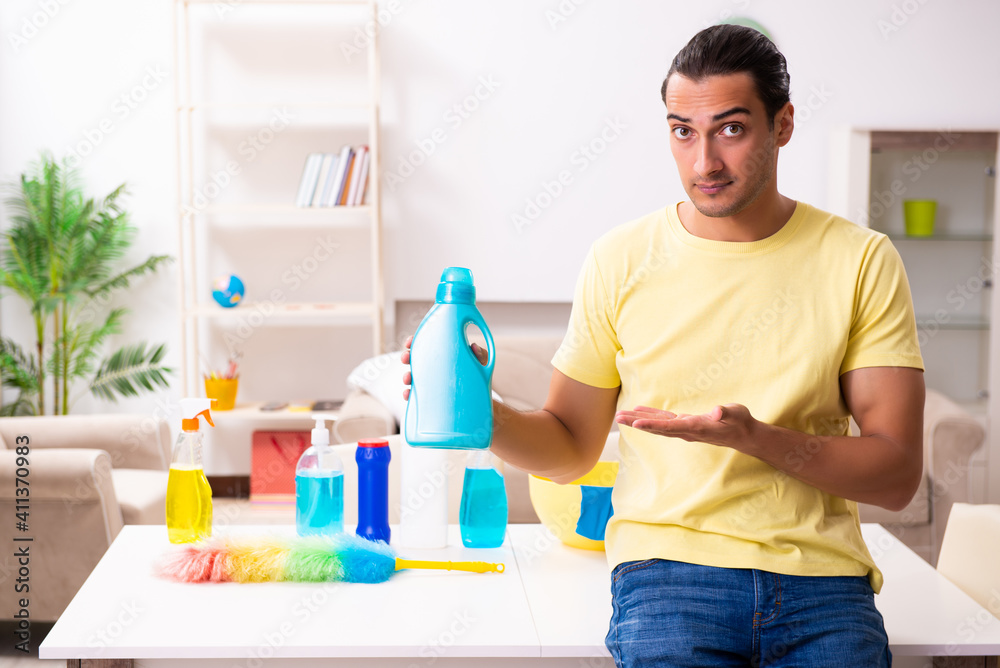Young male contractor doing housework at home Young male contractor doing housework at home