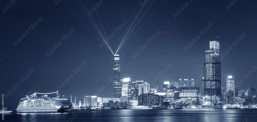 Laser show in Victoria Harbor of Hong Kong city at night