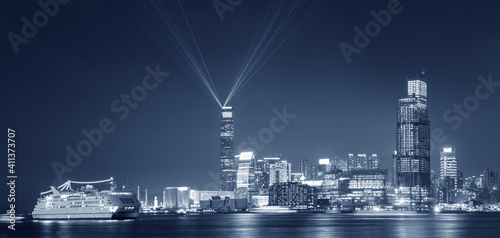 Laser show in Victoria Harbor of Hong Kong city at night