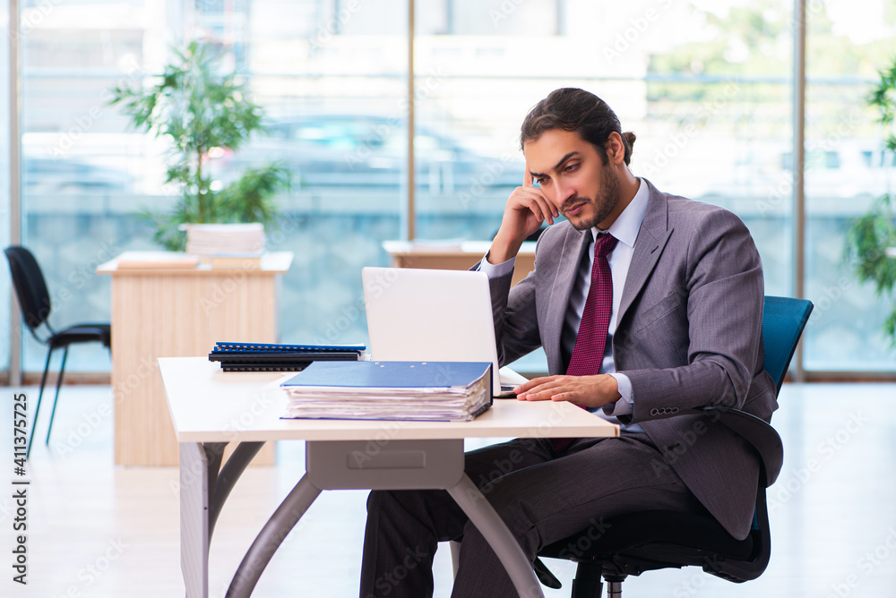 Young male employee working in the office