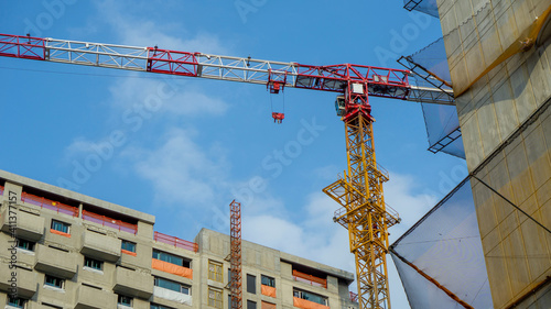 Construction site with cranes on sky background