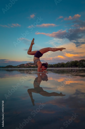 Yoga Inversion Pose on a beach at low tide