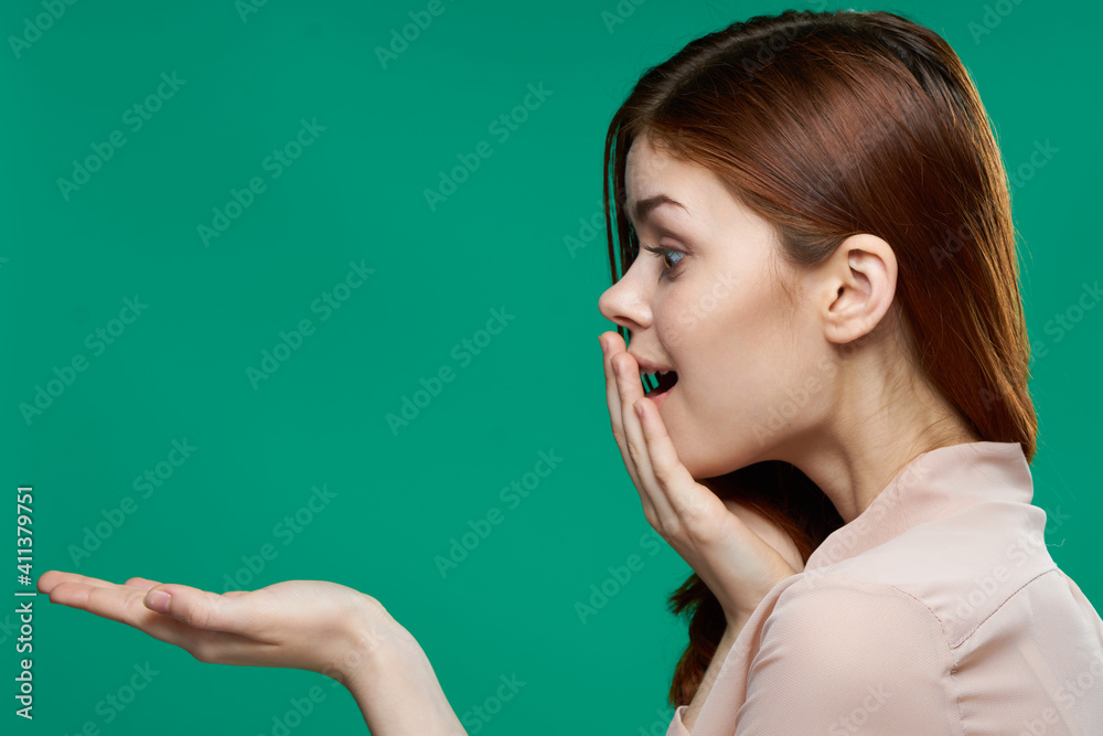 surprised woman holding palms in front of her emotions side view close-up green background surprised woman holding palms in front of her emotions side view close-up green background