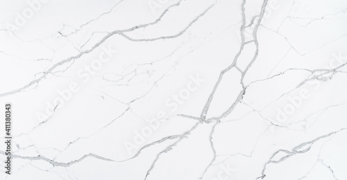 This quartz slab is designed to mimic the look of Statuario Marble. It contains bold grey veins which are outlined in a cool-toned dark grey with subtle grey shoelace veins for a natural look.