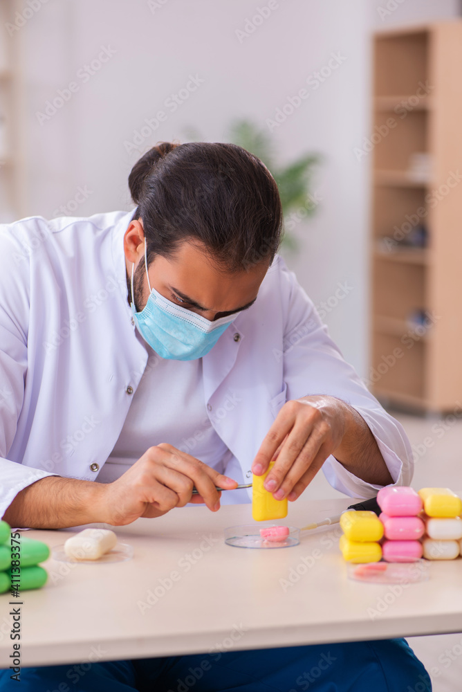 Young male chemist testing soap in the lab Young male chemist testing soap in the lab