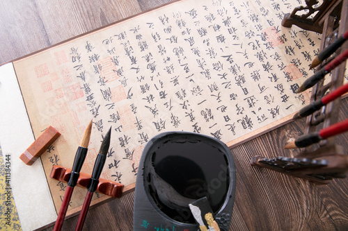 Calligraphy works, brushes, inkstones and other related articles spread out on the table photo