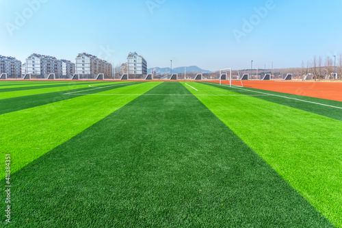 Football pitch and a cloudy sky. Green field. © 昊 周