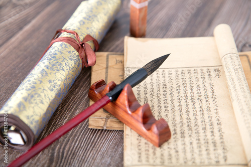 Put away the brush and ancient books and scroll painting works beside them photo