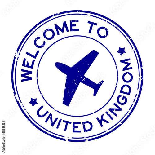 Grunge blue welcome to United Kingom word with airplane icon round rubber seal stamp on white background