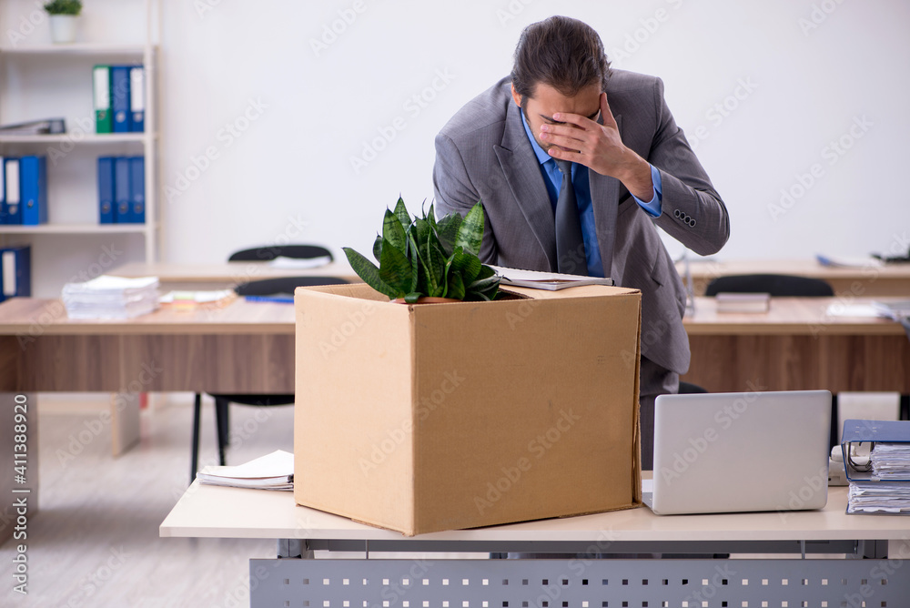 Young male employee being fired from his work Young male employee being fired from his work