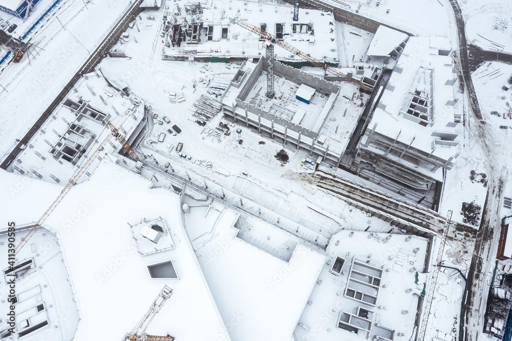 new multistory complex under construction. aerial top view in foggy winter day new multistory complex under construction. aerial top view in foggy winter day