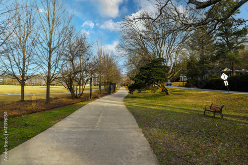 a long winding paved bike path with  lush green and autumn colored trees and grass along the path at Tanyard Creek Park in Atlanta Georgia photo