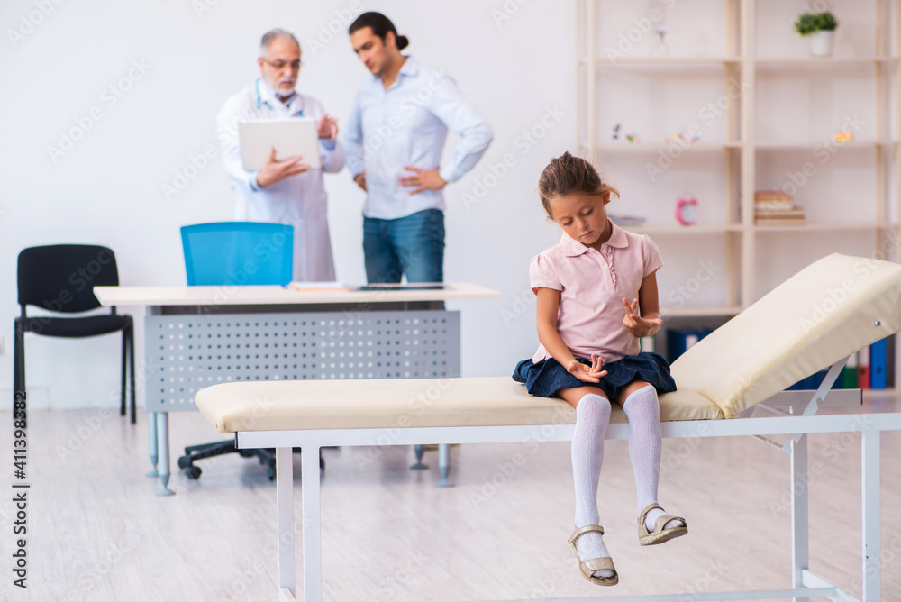 Small girl with her father visiting old male doctor Small girl with her father visiting old male doctor