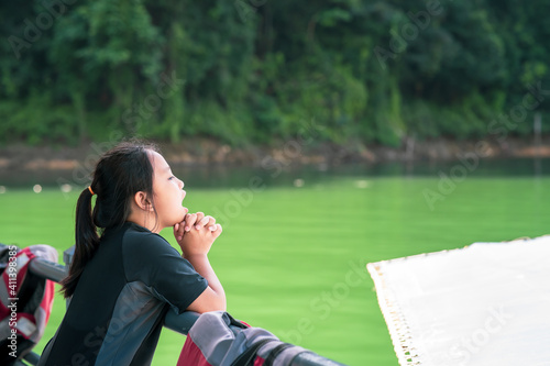 Casual portrait of little girl  in outdoor on summer day enjoying boat ride or fishing trip © ellinnur