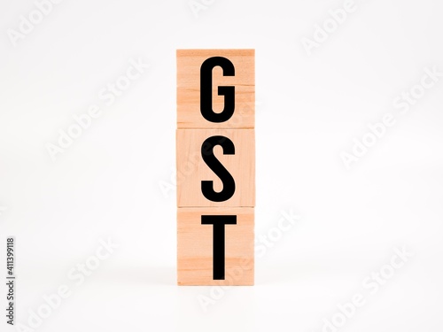 Wooden blocks alphabet "GST" isolate on a white background. Tax concept.