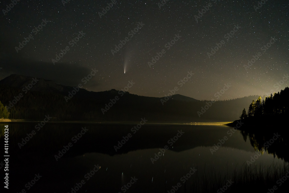 NEOWISE Comet above lake low above horizon