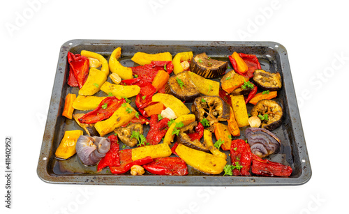 Slices of baked seasonal vegetables on baking sheet.