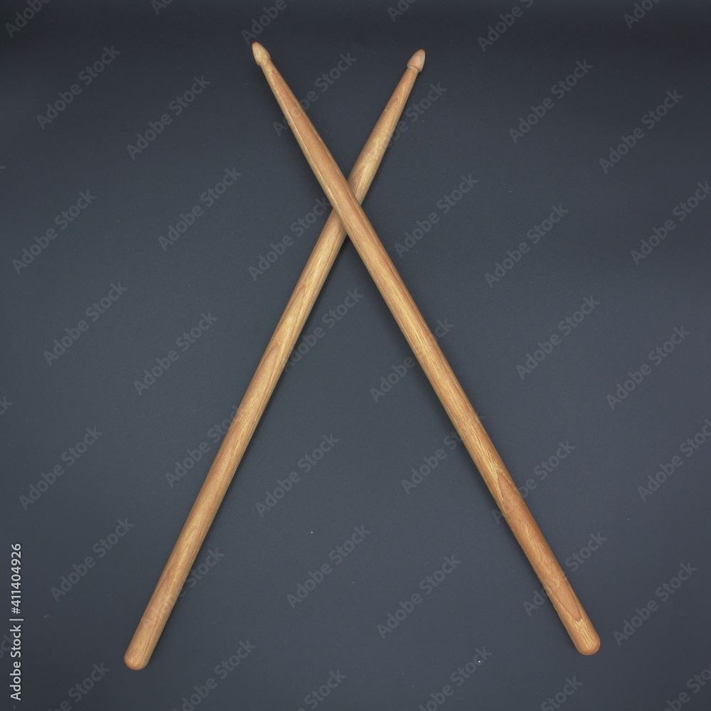Crossed percussion drumsticks on a black background. Crossed percussion drumsticks on a black background.