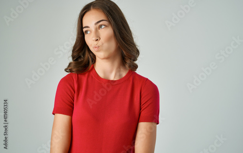 Pretty woman in red t-shirt lifestyle emotions gray background