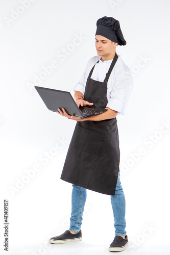Chef with a laptop in his h...