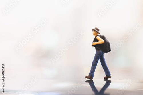 Miniature people : Traveler with backpack walking on emptry space for text  , Travel  concepts. photo