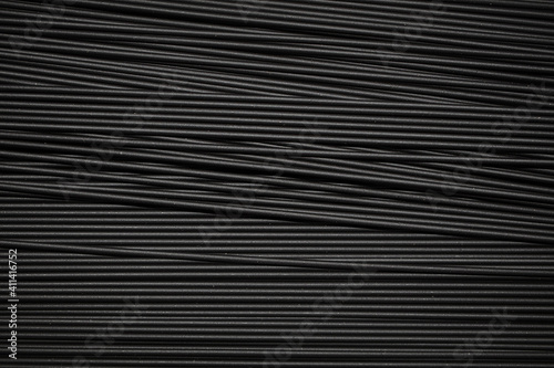 Black spaghetti background. Spaghetti squid ink "romagnola" style.