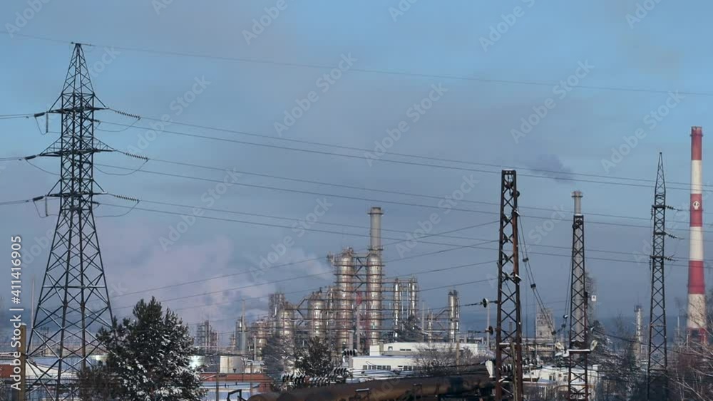 The chimneys of thermal power plants spew smoke into the air against the blue winter sky. CHPP is a thermal power plant in Angarsk, Russia. The chimneys of thermal power plants spew smoke into the air against the blue winter sky. CHPP is a thermal power plant in Angarsk, Russia.