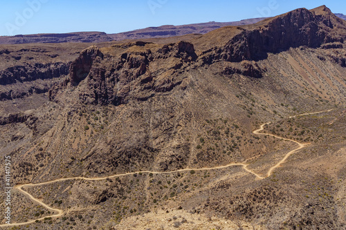 aerial view of the mountains of Gran Canaria with a road that goes around the hillside making curves. Spain. photo