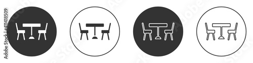Black Picnic table with chairs on either side of the table icon isolated on white background. Circle button. Vector.