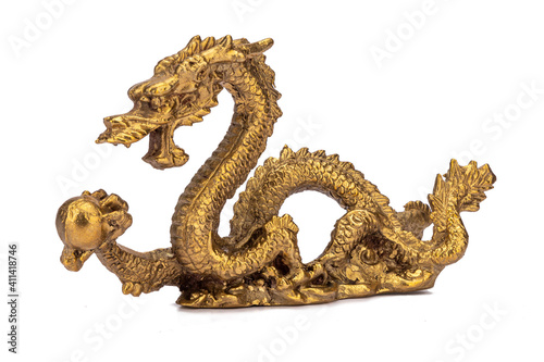 Bronze sculpture dragon holding pearl isolated on white background. Chinese symbol prosperity, wealth, good luck. Feng Shui. Side view © Sergey