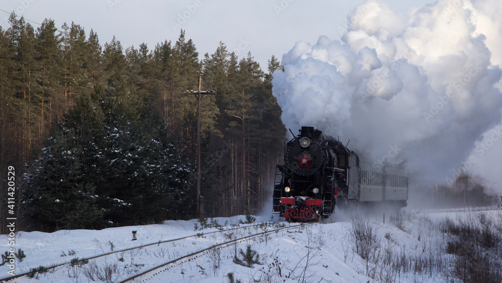 Fototapeta premium Vintage black steam locomotive in Russia in the winter.