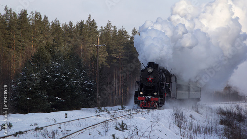 Vintage black steam locomotive in Russia in the winter.