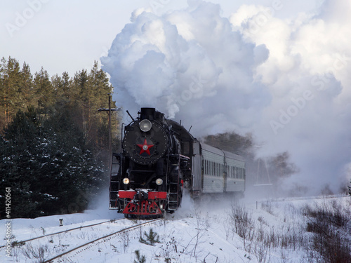 Vintage black steam locomotive in Russia in the winter.