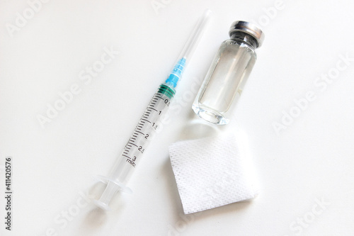 Medical layout. A bottle of vaccine and an injection syringe. The view from the top.Concept vaccination coronavirus