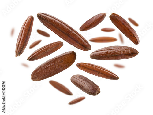 Cuadro en lienzo Raw brown rice in the shape of a heart on a white background