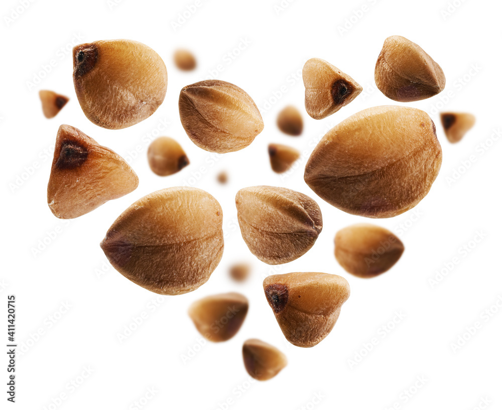 Ripe buckwheat grains in the shape of a heart on a white background Ripe buckwheat grains in the shape of a heart on a white background