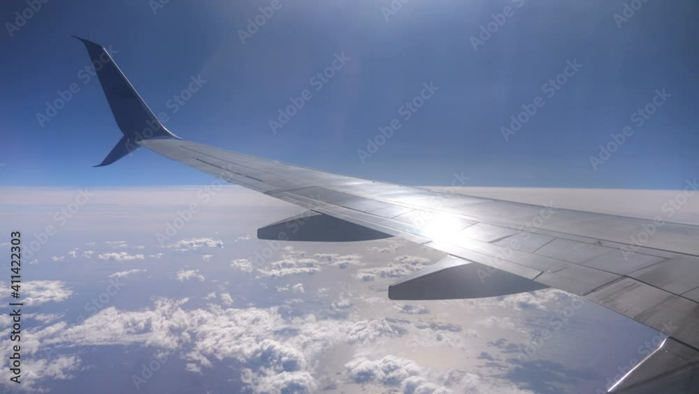Airplane wing above clouds during flight in 4K Slow motion 60fps Airplane wing above clouds during flight in 4K Slow motion 60fps
