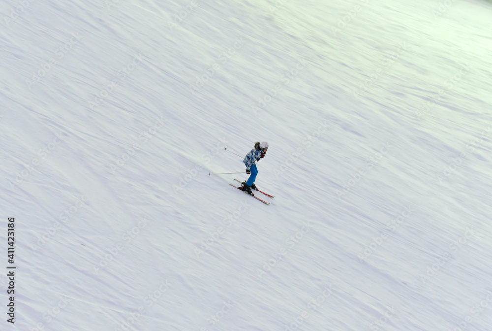 Downhill skier. Snowboarders and skier ride on snow in the mountains. Downhill ride. Adventure skiers season. Skiing and Snowboarding Resorts. Ski and snowboard equipment. Snow sports enthusiasts