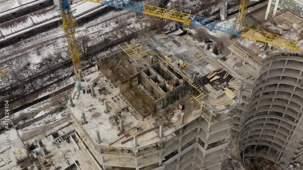 Building construction site. Сity development. Building machinery and high-rise houses in progress. Construction site with cranes - aerial drone view. Work of special equipment. Building construction site. Сity development. Building machinery and high-rise houses in progress. Construction site with cranes - aerial drone view. Work of special equipment.