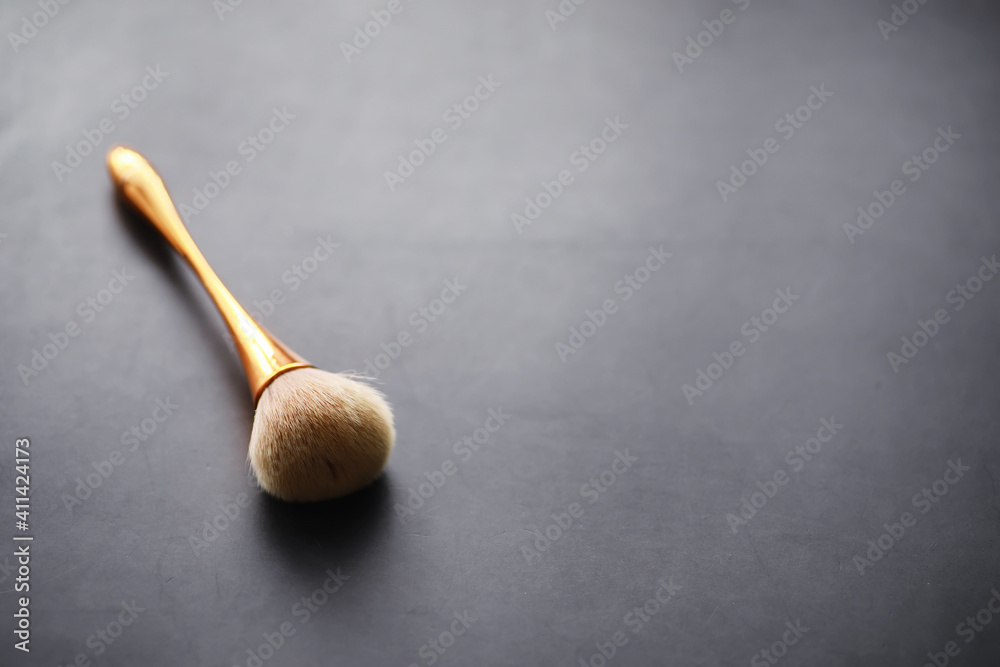 Powder and makeup brush. Brown powder on the background. Makeup products. Style concept. Powder and makeup brush. Brown powder on the background. Makeup products. Style concept.