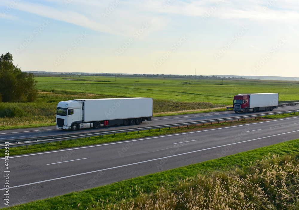 Truck with semi-trailer driving along highway. Out of focus, possible granularity, motion blur Truck with semi-trailer driving along highway. Out of focus, possible granularity, motion blur