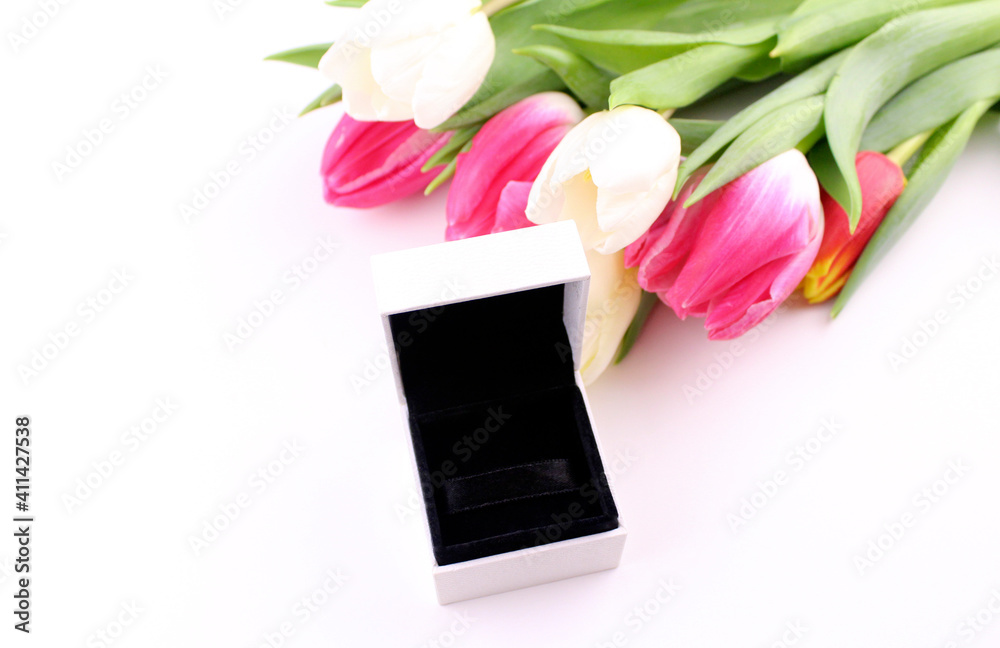 Open white gift box with a bouquet of tulips. Gift for a woman on women's day Open white gift box with a bouquet of tulips. Gift for a woman on women's day