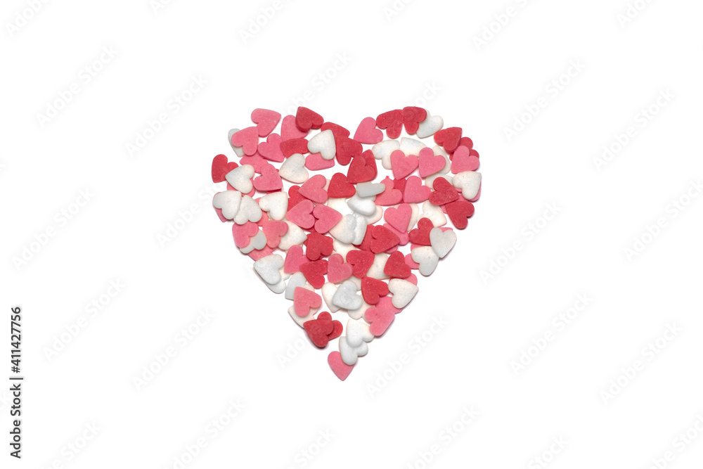 Sweet hearts. Pink, red and white heart shaped sugar sprinkles. Colorful heart made of lots of little hearts. Valentine's day or Mothers day background or card.