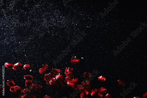 Water drops on ripe sweet pomegranate seeds. Fresh pomegranate background with copy space for your text. Vegan concept.